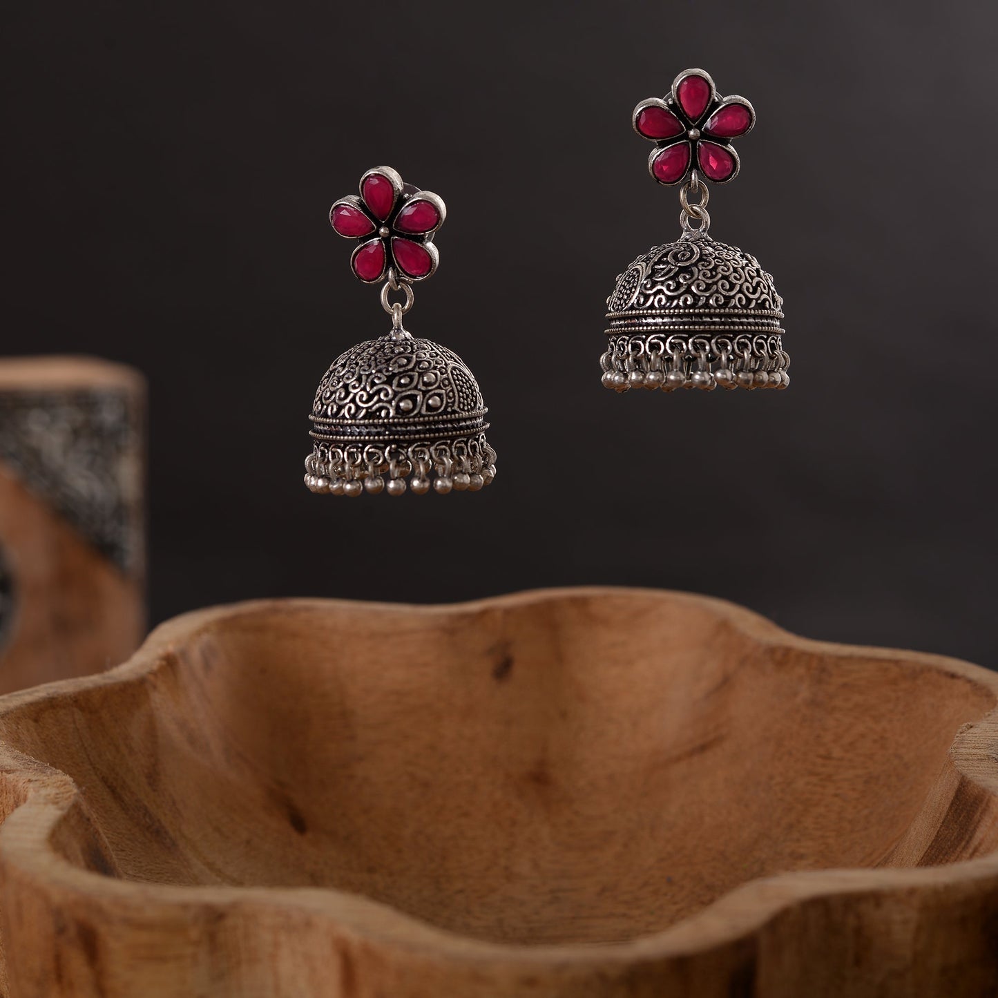 Champika- Silver Brass Stone Studded Jhumka Earrings(Red)