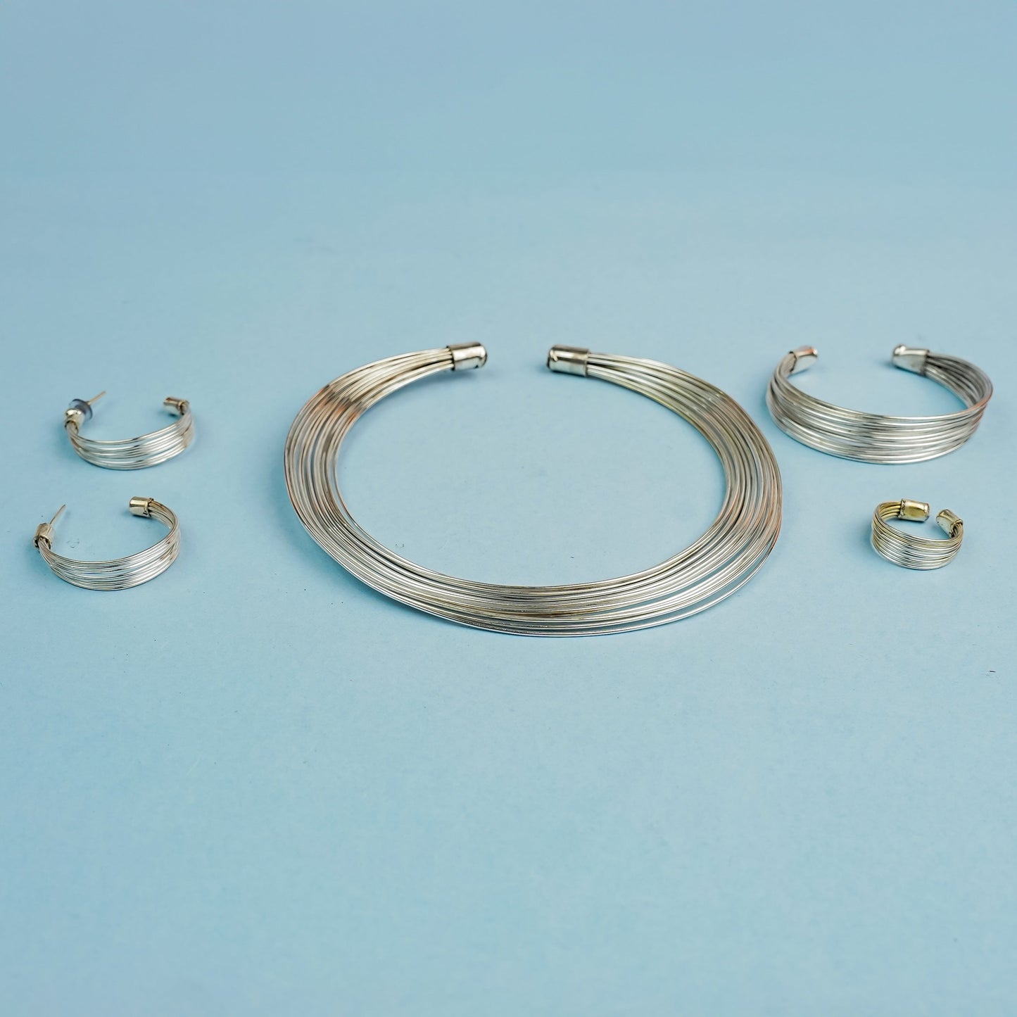 Hemaprabha- Multistrand Brass polished Hasli with Earrings & Adjustable Ring