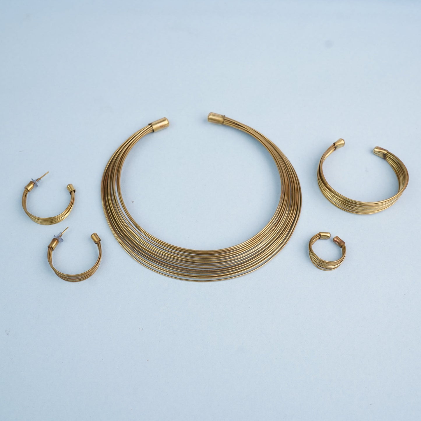 Chitrangada- Multistrand Brass polished Hasli with Earrings & Adjustable Ring