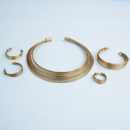 Chitrangada- Multistrand Brass polished Hasli with Earrings & Adjustable Ring